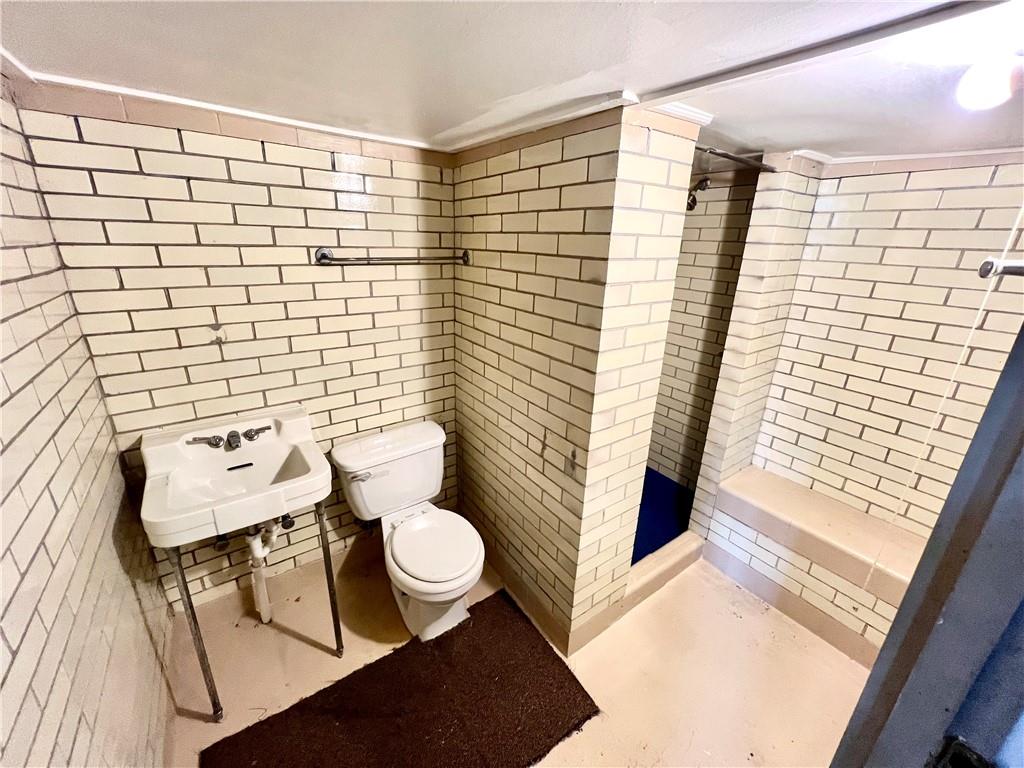 1032 Main Street Republic, PA 15475 - Photo 22 of 39 a bathroom with a sink a toilet and shower curtain