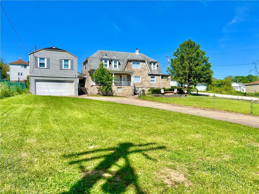 1032 Main Street Republic, PA 15475 - Photo 3 of 39 a view of a big house with a big yard and large trees