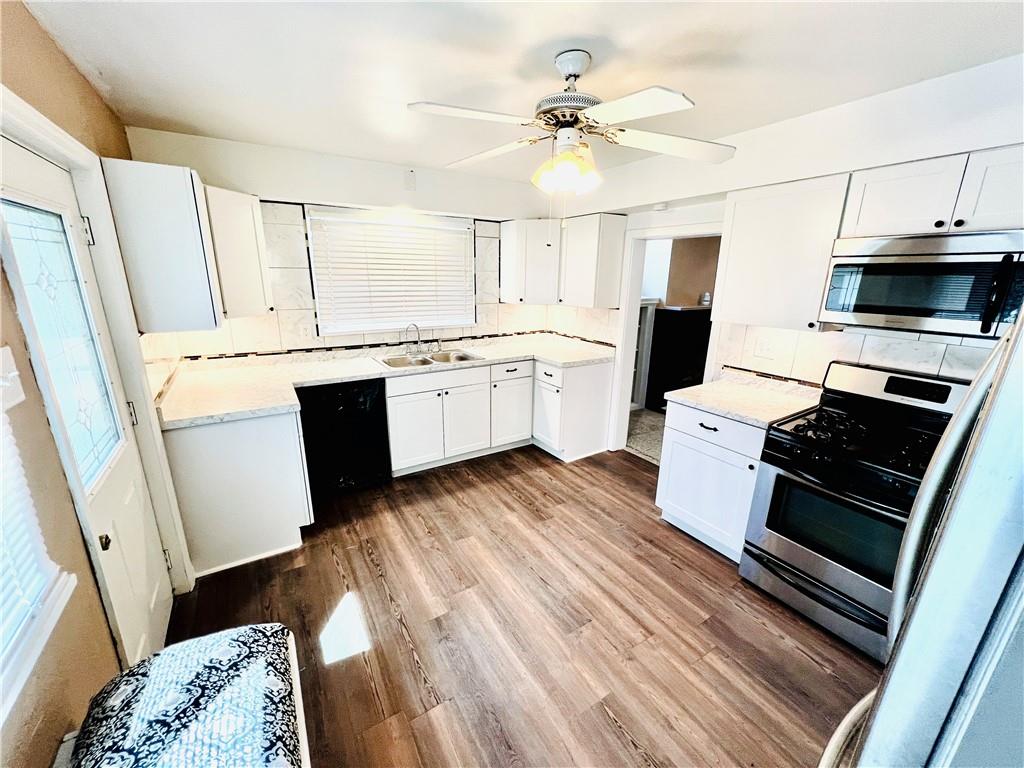 1032 Main Street Republic, PA 15475 - Photo 5 of 39 a kitchen with granite countertop a stove refrigerator and microwave