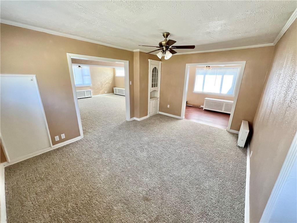 1032 Main Street Republic, PA 15475 - Photo 8 of 39 a view of a big room with windows and chandelier fan