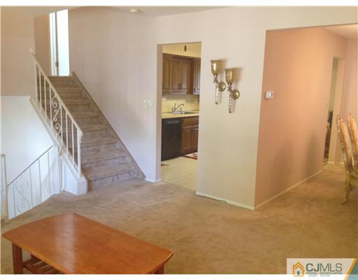29 Sherwood Road Edison, NJ 08820 - Photo 11 of 12 a view of a hallway with wooden floor and entryway