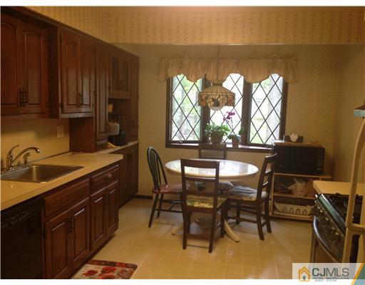 29 Sherwood Road Edison, NJ 08820 - Photo 7 of 12 a kitchen with a chair and cabinets