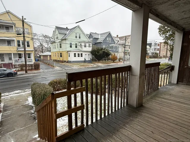 a view of a balcony with wooden floor