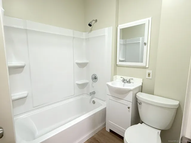 a bathroom with a toilet a sink and bathtub