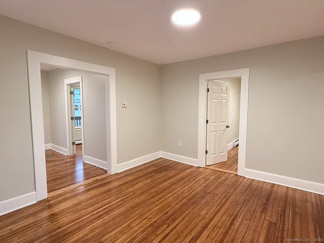 wooden floor in an empty room with a window