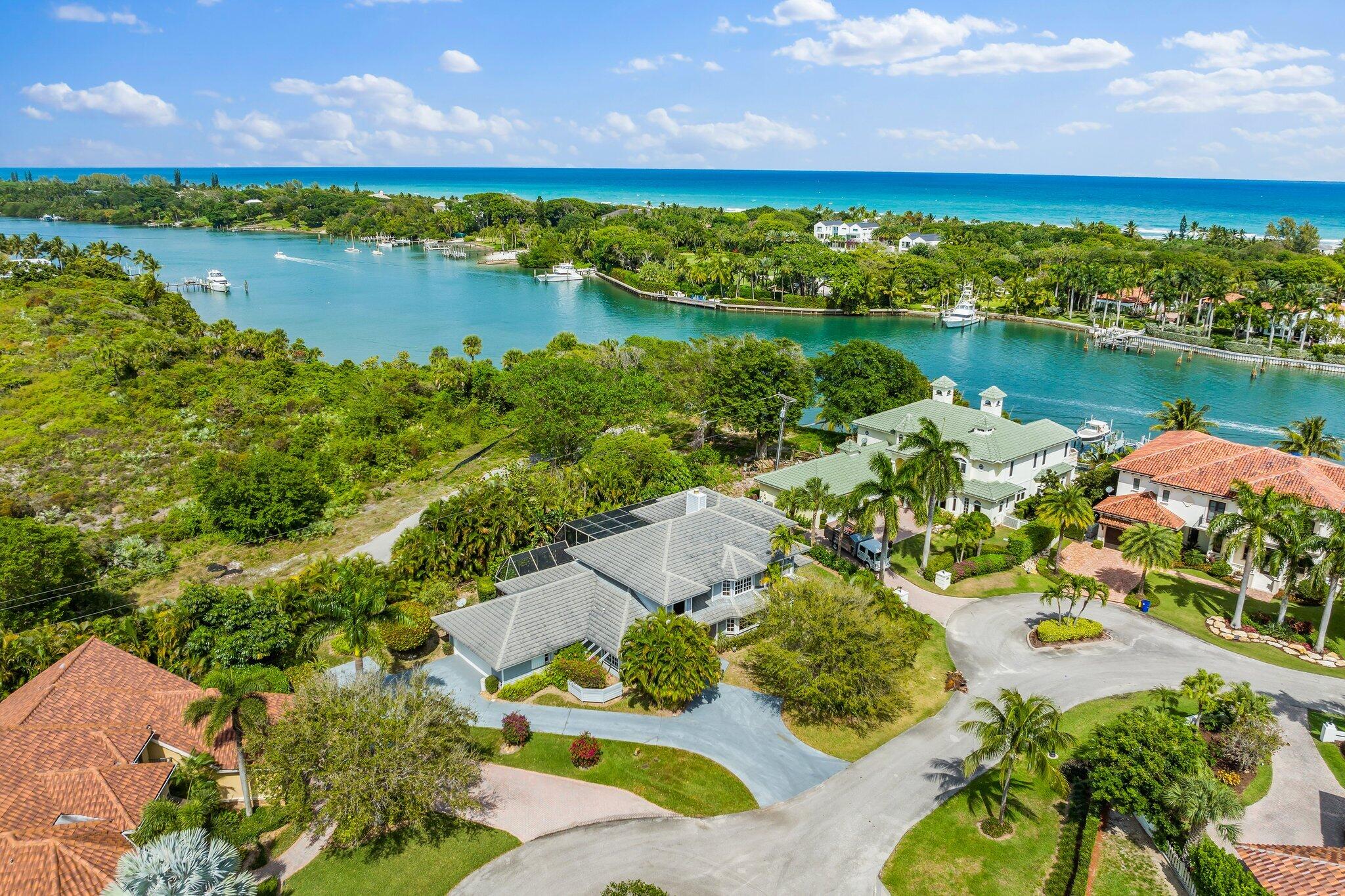 17129 Southeast Limerick Court Tequesta, FL 33469 - Photo 67 of 80 an aerial view of a houses with a lake view