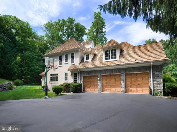 a front view of a house with a garden and yard