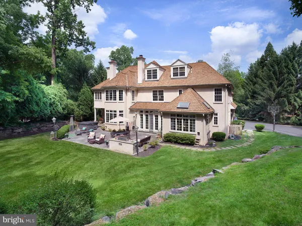 a view of a house with a yard and sitting area