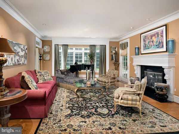a living room with furniture large window and a fireplace