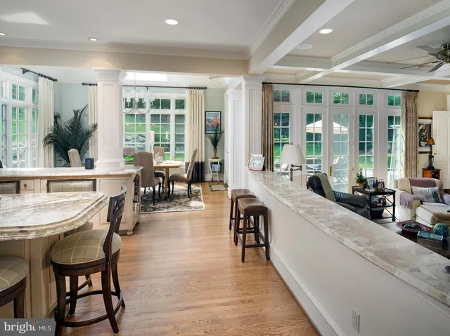 a large living room with large windows and furniture