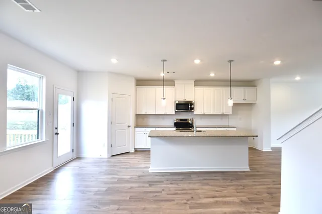 a view of kitchen with wooden floor and window