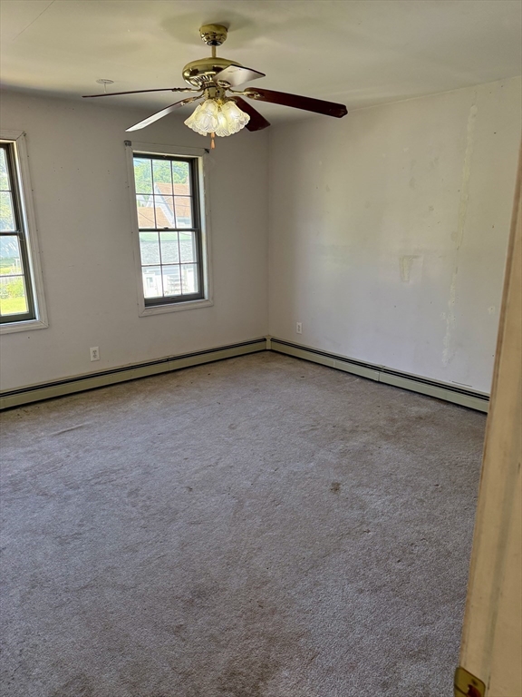 111 Hayden Street Orange, MA 01364 - Photo 16 of 26 an empty room with windows and fan