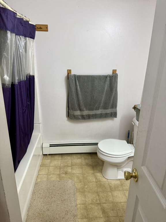 111 Hayden Street Orange, MA 01364 - Photo 24 of 26 a bathroom with a toilet and a shower curtain