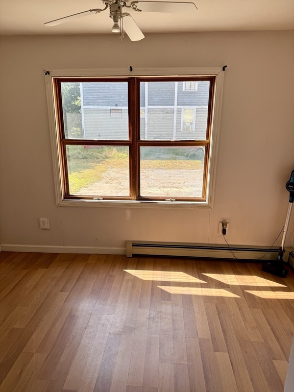 111 Hayden Street Orange, MA 01364 - Photo 10 of 26 an empty room with wooden floor and windows