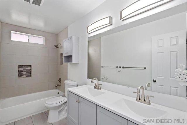 an empty room with a wooden floor and windows