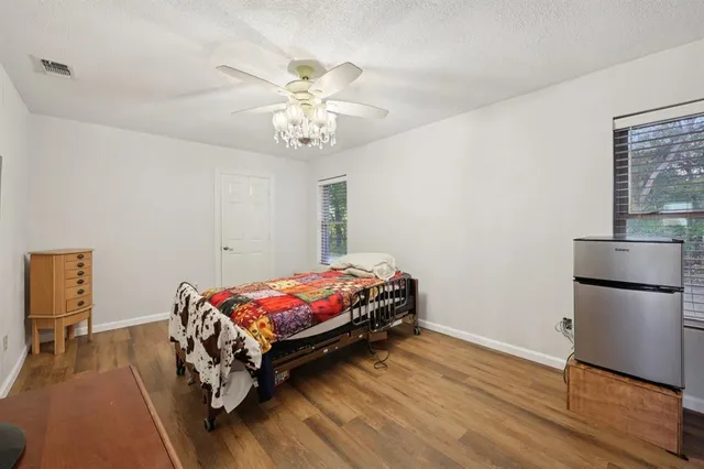 a bedroom with a bed and a chandelier
