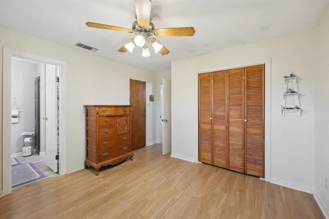 wooden floor in an empty room with a bathroom