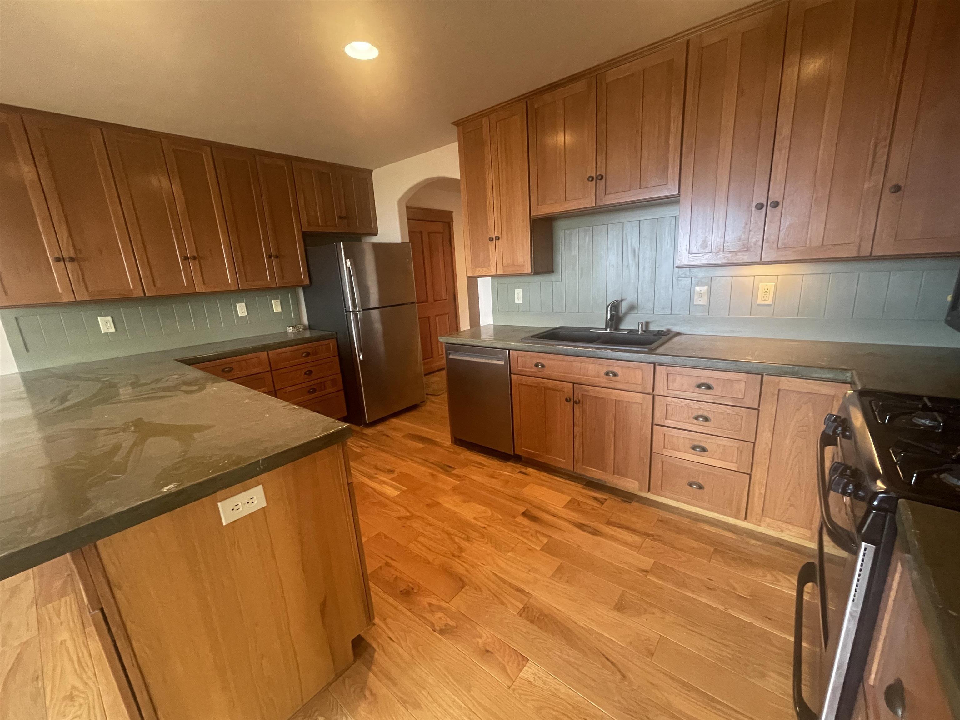 117 Summit Road, Unit 2 Bishop, CA 93514 - Photo 5 of 19 a kitchen with stainless steel appliances granite countertop a sink refrigerator and cabinets