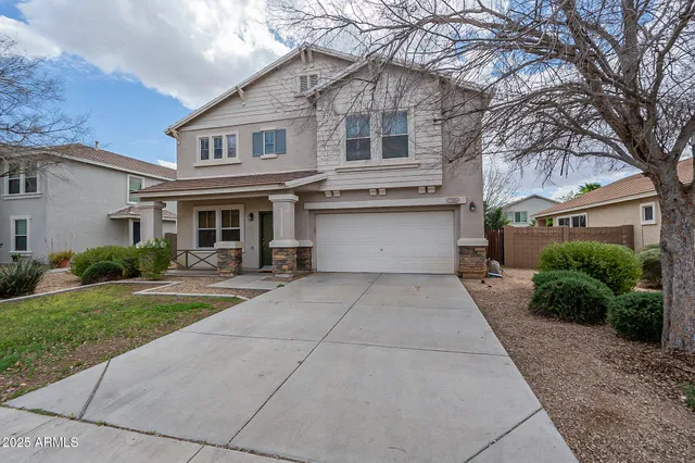 a front view of a house with a yard and a garage