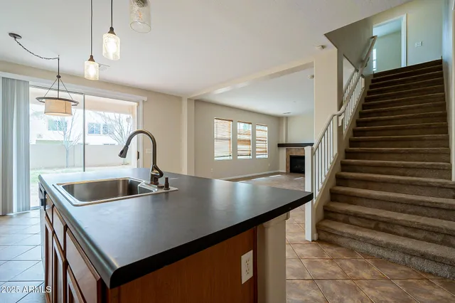 an open kitchen with fireplace and cabinets