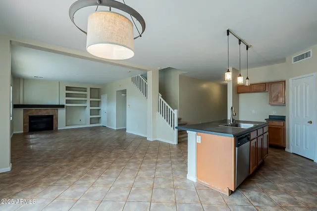 a view of an empty room with fireplace and a window