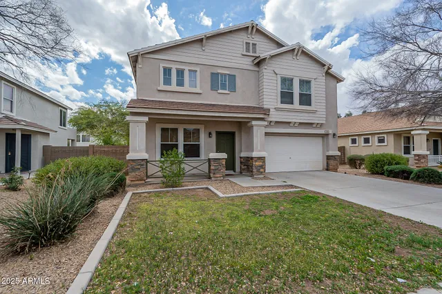 a front view of a house with yard and porch
