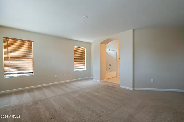 an empty room with windows and closet