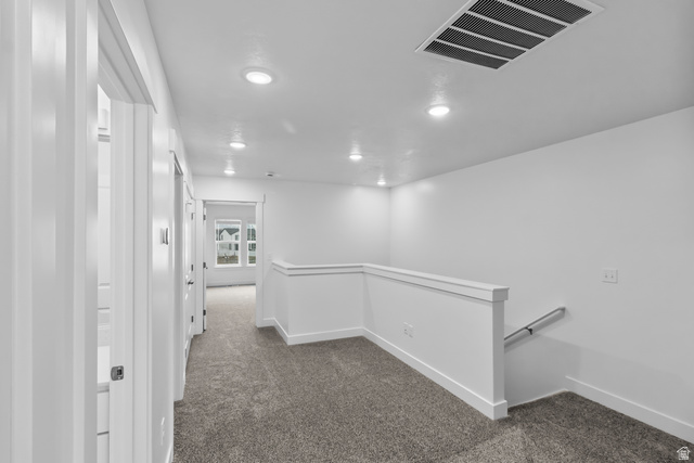3014 South 265th Street West Logan, UT 84321 - Photo 13 of 25 Upper-level landing featuring plush gray carpeting, recessed lighting, white trim work, and a contemporary stairwell railing