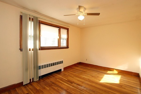 111 Silver Brook Road Milton, MA 02186 - Photo 11 of 28 a view of an empty room with a window and wooden floor