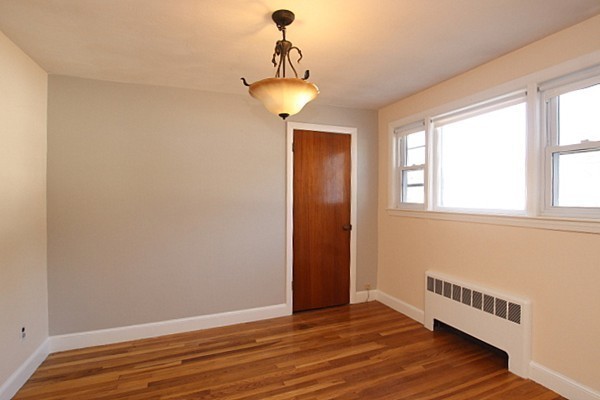 111 Silver Brook Road Milton, MA 02186 - Photo 12 of 28 a view of an empty room with wooden floor and a window
