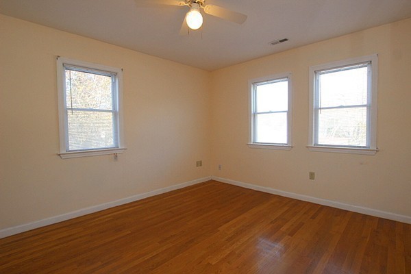 111 Silver Brook Road Milton, MA 02186 - Photo 16 of 28 an empty room with wooden floor and windows