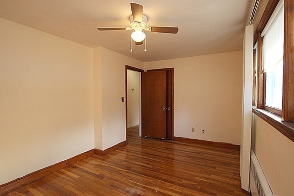 111 Silver Brook Road Milton, MA 02186 - Photo 17 of 28 a view of an empty room with wooden floor and a window