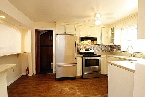 111 Silver Brook Road Milton, MA 02186 - Photo 6 of 28 a kitchen with a refrigerator a stove top oven a sink and cabinets