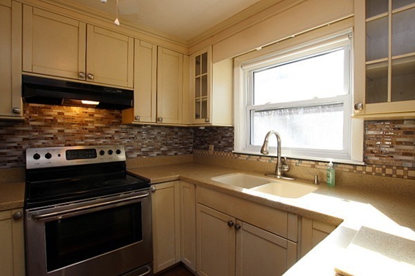 111 Silver Brook Road Milton, MA 02186 - Photo 7 of 28 a kitchen with granite countertop a sink stainless steel appliances and cabinets