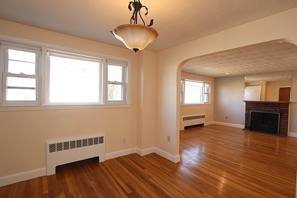 111 Silver Brook Road Milton, MA 02186 - Photo 9 of 28 a view of an empty room with a window and wooden floor