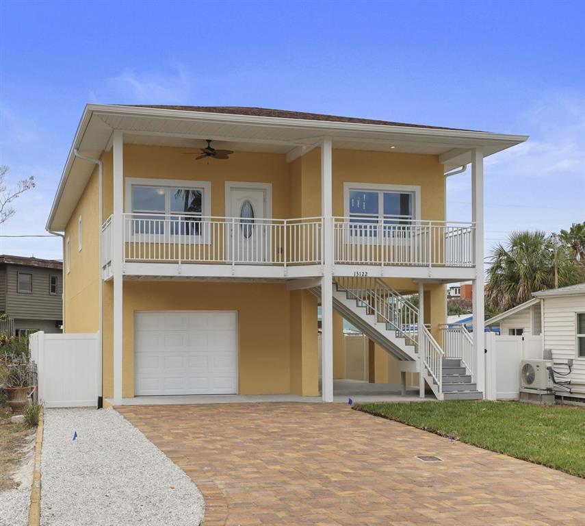 13122 4th Street East Madeira Beach, FL 33708 - Photo 1 of 1 a front view of a house with a yard