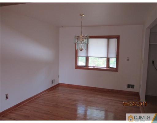 23 Louise Road Edison, NJ 08817 - Photo 3 of 8 a view of a room with wooden floor fan and window