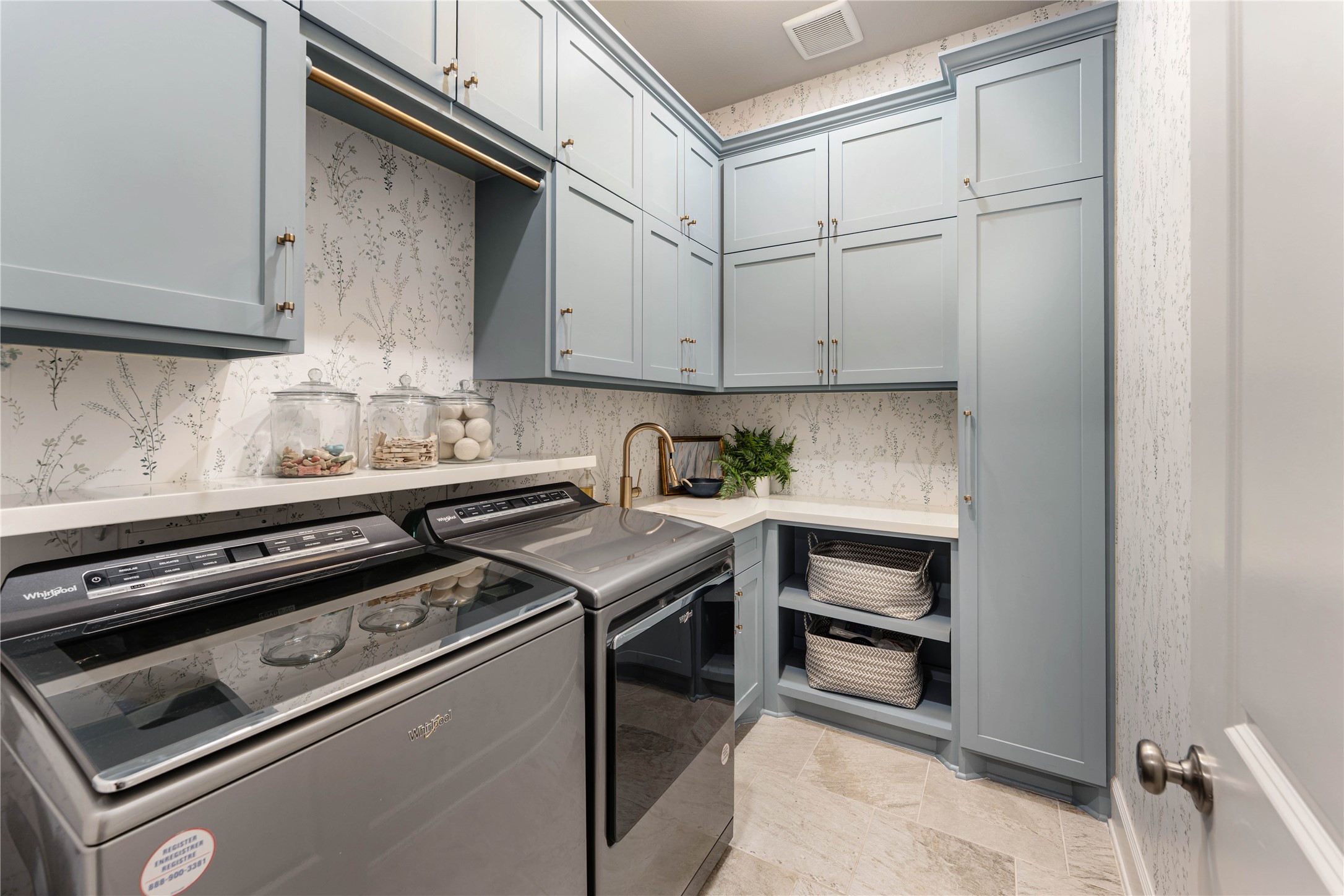 155 Rockwell Park Spring, TX 77389 - Photo 17 of 41 Light blue cabinetry extends into the remodeled laundry room providing an abundance of storage, sink, and plenty of counter space.