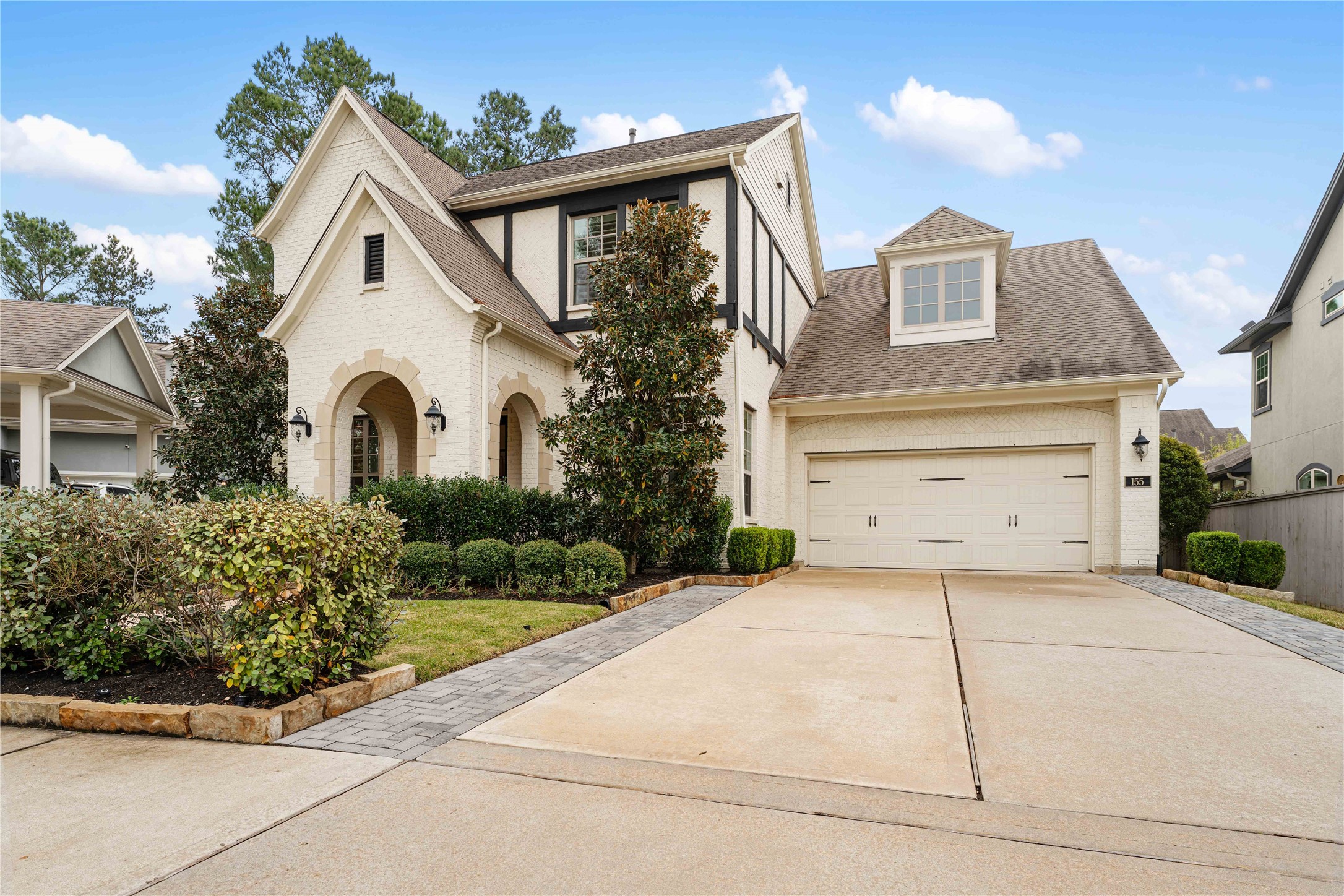 155 Rockwell Park Spring, TX 77389 - Photo 2 of 41 This charming two-story home features a classic brick exterior, a welcoming arched entryway, and lush greenery. The extended driveway leads you to the spacious, 3 car tandem garage.