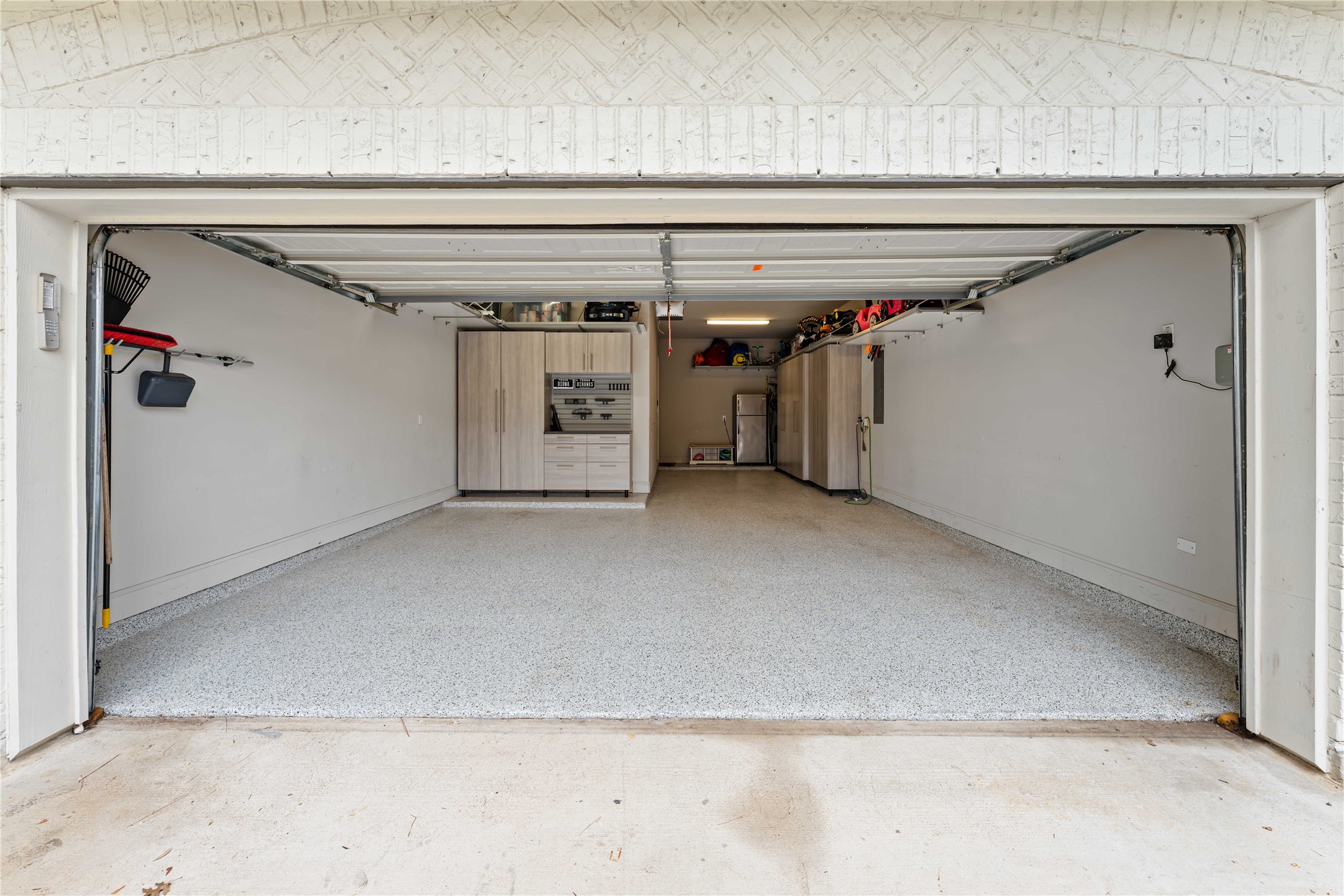 155 Rockwell Park Spring, TX 77389 - Photo 35 of 41 The spacious 3 car garage with epoxy flooring, built-in storage cabinets, and wall-mounted organization. Ideal for parking and storage!