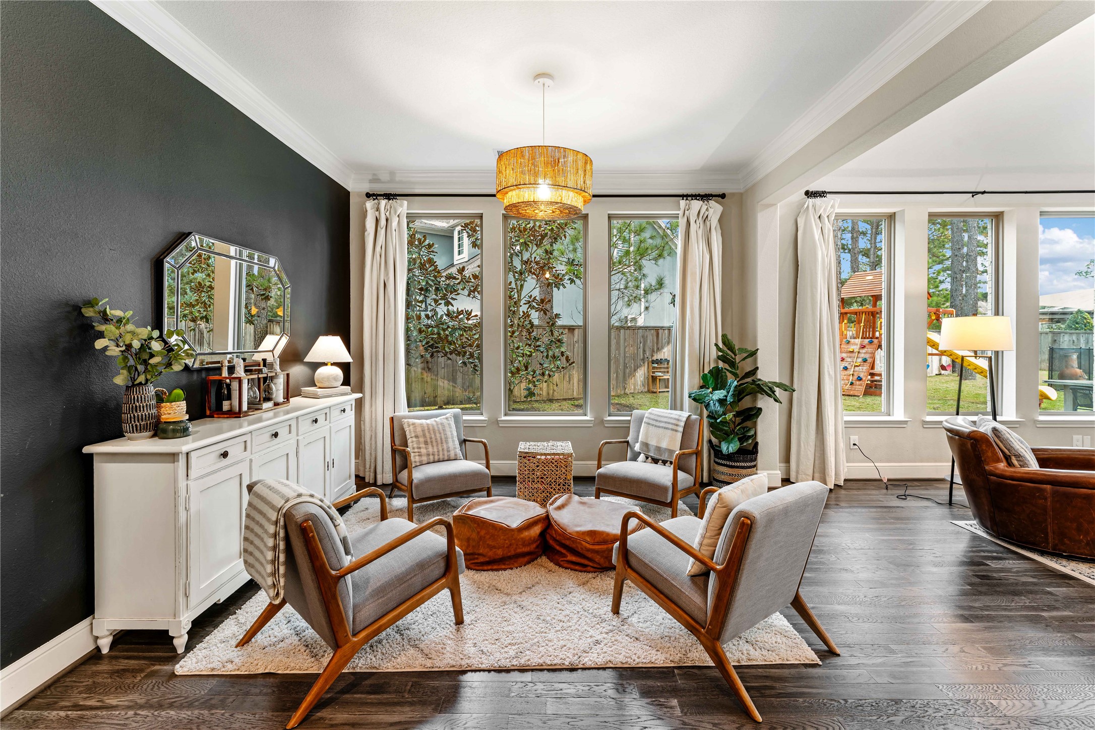 155 Rockwell Park Spring, TX 77389 - Photo 8 of 41 This inviting living space features dark hardwood floors, a bold accent wall, and large windows offering plenty of natural light. The space can be easily transformed into a dining area!