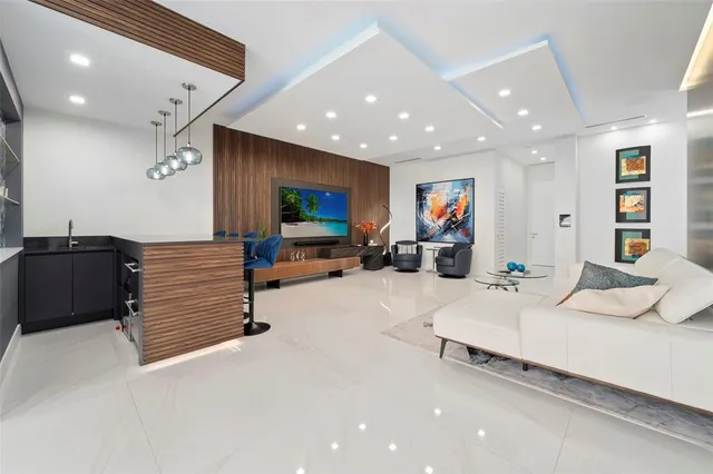 a kitchen with stainless steel appliances granite countertop a sink and a refrigerator