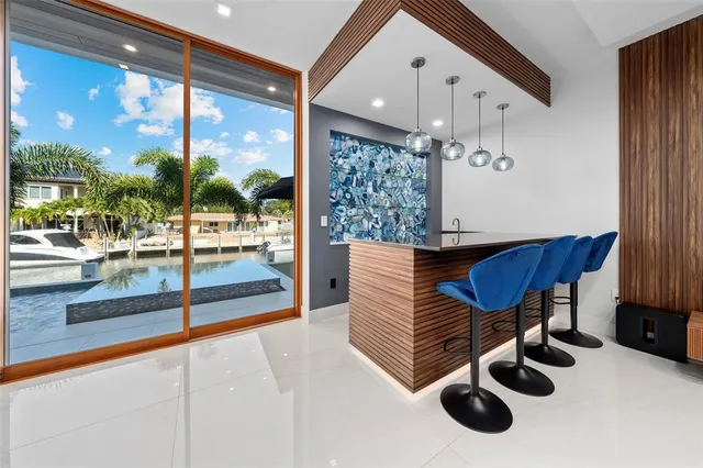 a living room with couches bookshelf and a flat screen tv