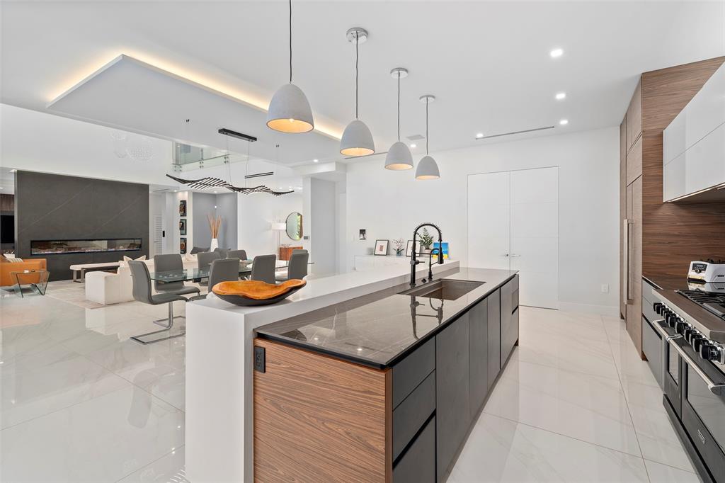 2631 Northeast 48th Court Lighthouse Point, FL 33064 - Photo 20 of 74 a kitchen with stainless steel appliances granite countertop a sink and a refrigerator