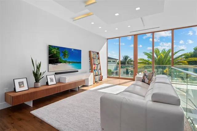 a living room with furniture and large windows