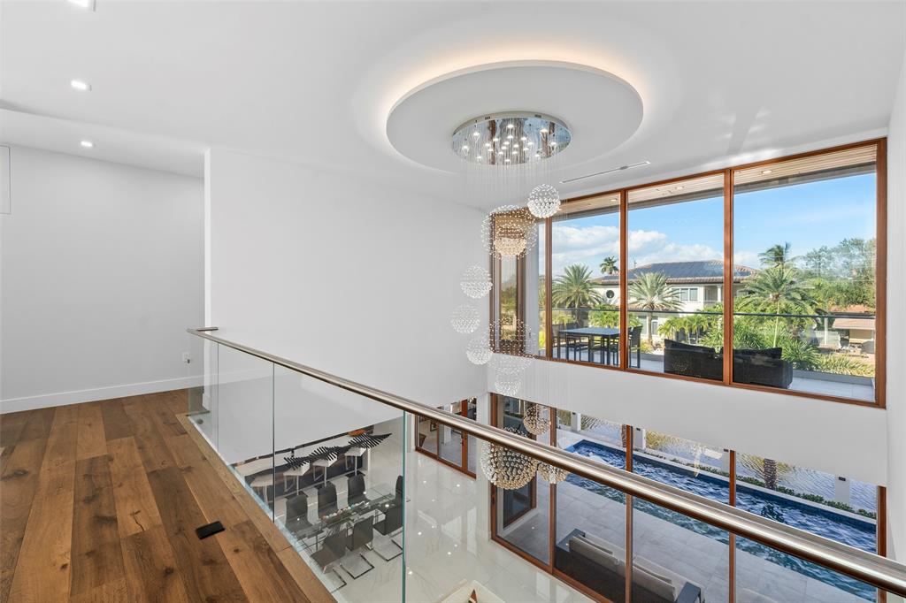 2631 Northeast 48th Court Lighthouse Point, FL 33064 - Photo 25 of 74 a very nice looking room with wooden floor and windows