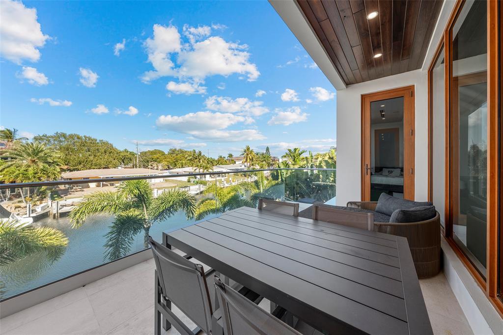 2631 Northeast 48th Court Lighthouse Point, FL 33064 - Photo 29 of 74 a view of a balcony with lake view and a potted plant