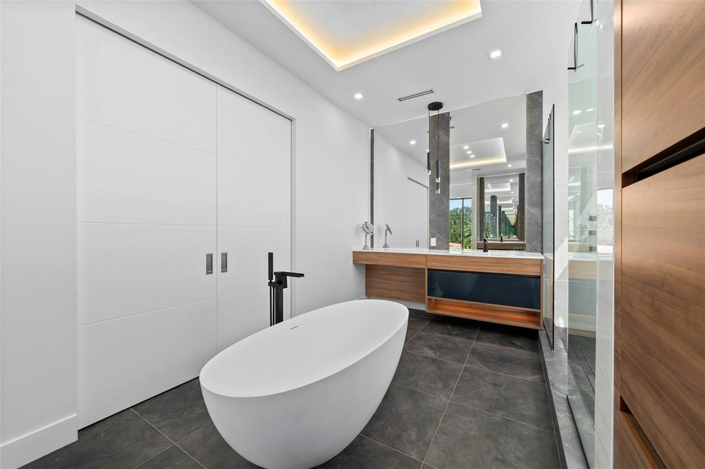 2631 Northeast 48th Court Lighthouse Point, FL 33064 - Photo 33 of 74 a bathroom with a white tub shower and sink