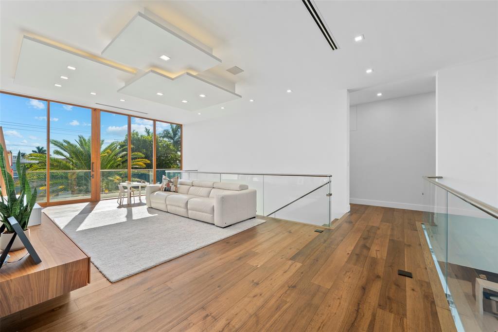 2631 Northeast 48th Court Lighthouse Point, FL 33064 - Photo 38 of 74 a living room with furniture and large windows