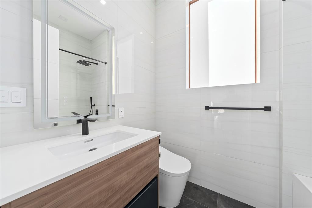 2631 Northeast 48th Court Lighthouse Point, FL 33064 - Photo 40 of 74 a bathroom with a sink toilet a mirror and shower